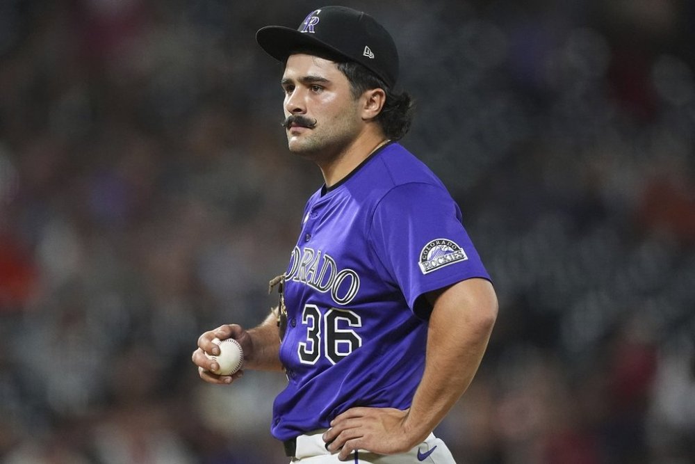 Colorado Rockies relief pitcher Zach Agnos waits to be pulled from the mound after issuing a walk to San Francisco Giants' Willy Adames in the ninth inning of a baseball game Tuesday, June 10, 2025, in Denver. (AP Photo/David Zalubowski)