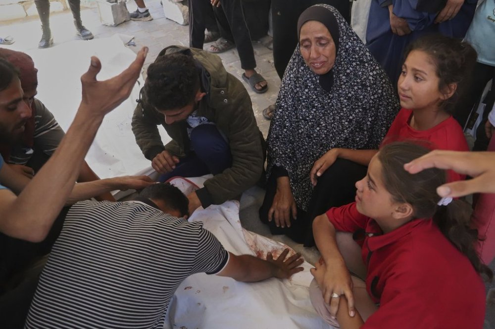 Relatives mourn over the body of Palestinian teenager Ghazal Eyad, 16, who was killed while heading to an aid distribution hub, during her funeral in Rafah, southern Gaza Strip, Wednesday, June 11, 2025. (AP Photo/Mariam Dagga)