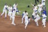 Toronto Blue Jays' base Addison Barger (front centre) celebrates with teammates after hitting a walk off RBI single to defeat the Los Angeles Angels in the eleventh inning of MLB baseball action in Toronto on Saturday July 5, 2025. THE CANADIAN PRESS/Chris Young