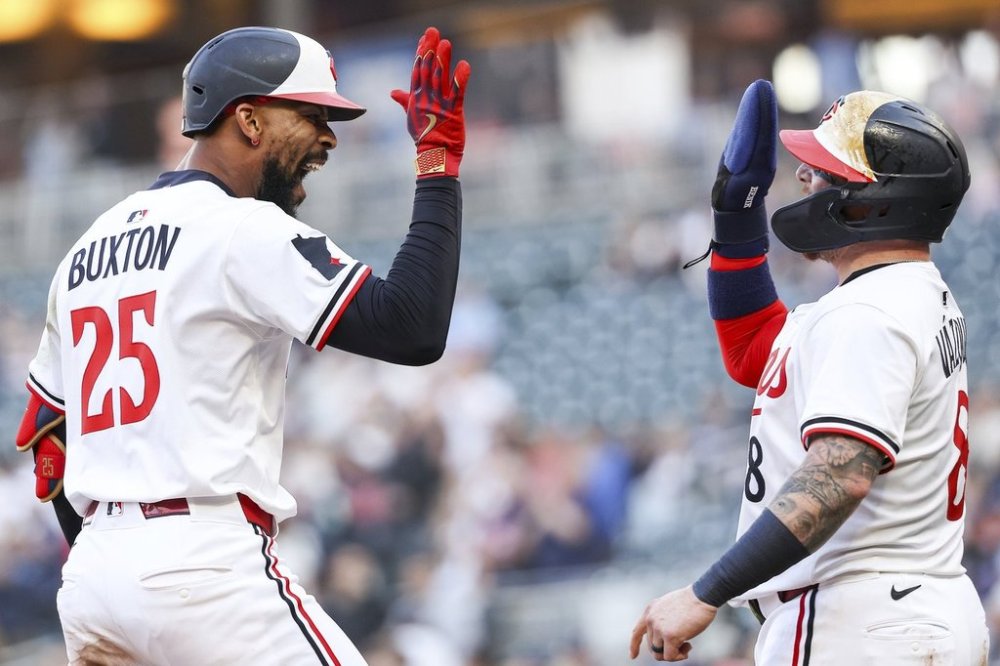 Minnesota Twins' Byron Buxton, left, celebrates his three-run home run with Christian Vázquez during the third inning of baseball game against the Texas Rangers, Wednesday, June 11, 2025, in Minneapolis. (AP Photo/Matt Krohn)