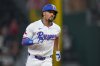 Texas Rangers' Marcus Semien runs the bases after hitting a three-run home run off Baltimore Orioles starting pitcher Tomoyuki Sugano during the third inning of a baseball game Wednesday, July 2, 2025, in Arlington, Texas. (AP Photo/Julio Cortez)