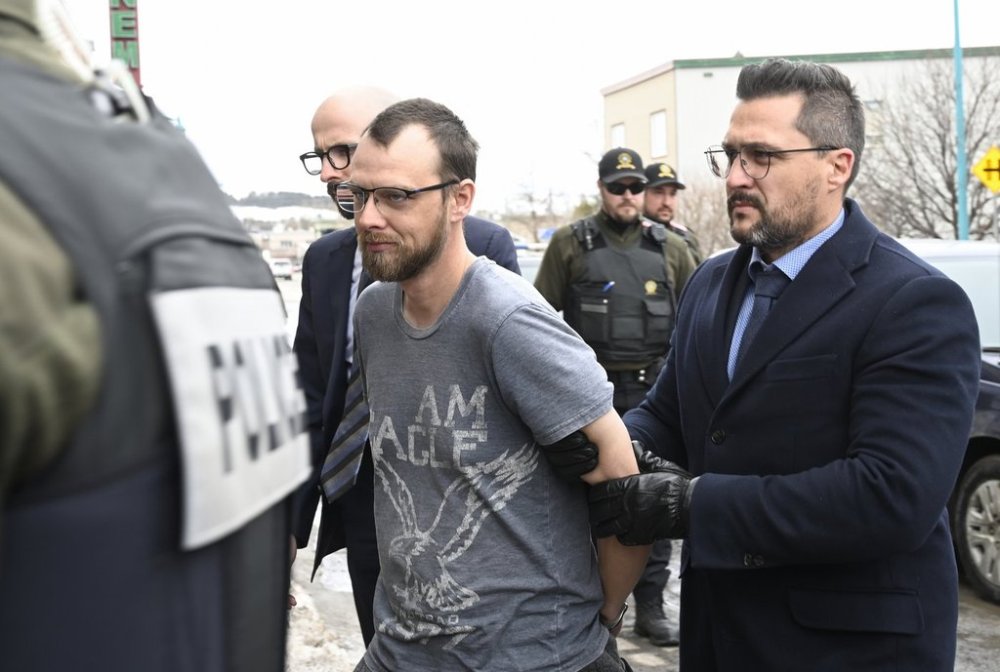 Steeve Gagnon is escorted by police into court in Amqui, Que., Tuesday, March 14, 2023. THE CANADIAN PRESS/Jacques Boissinot