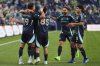 Seattle Sounders forward Danny Musovski (19) is greeted by teammates, including midfielder Kalani Kossa-Rienzi (85), midfielder Alex Roldan (16) and midfielder Obed Vargas, right, after scoring against Austin FC during the second half of an MLS soccer match Saturday, June 28, 2025, in Seattle. (AP Photo/Lindsey Wasson)