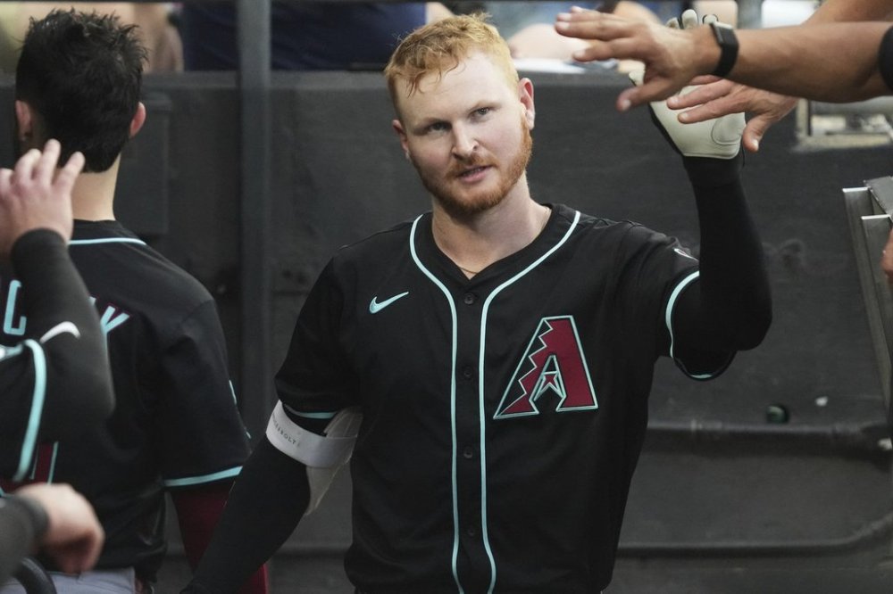 Arizona Diamondbacks' Pavin Smith celebrates with teammates after hitting a solo home run during the fourth inning of a baseball game against the Chicago White Sox in Chicago, Monday, June 23, 2025. (AP Photo/Nam Y. Huh)