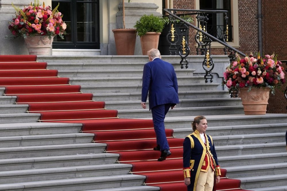 President Donald Trump climbs the stairs to the Paleis Huis ten Bosch ahead of the NATO summit in The Hague, Netherlands, Tuesday, June 24, 2025. (AP Photo/Alex Brandon)