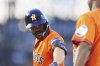 Houston Astros first base coach Dave Clark, right, congratulates Jose Altuve after his single to drive in two runs off Colorado Rockies relief pitcher Jake Bird in the sixth inning of a baseball game Wednesday, July 2, 2025, in Denver. (AP Photo/David Zalubowski)