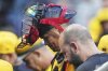 Pittsburgh Pirates catcher Endy Rodríguez, center, heads to the locker room with a team trainer before the beginning of the second inning a baseball game against the Philadelphia Phillies in Pittsburgh, Friday, June 6, 2025. (AP Photo/Gene J. Puskar)
