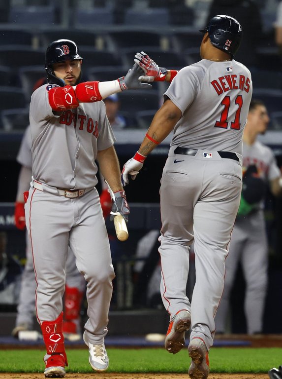 Boston Red Sox's Rafael Devers (11) celebrates with Wilyer Abreu after hitting a home run during the ninth inning of a baseball game against the New York Yankees , Sunday, June 8, 2025, in New York. (AP Photo/Noah K. Murray)