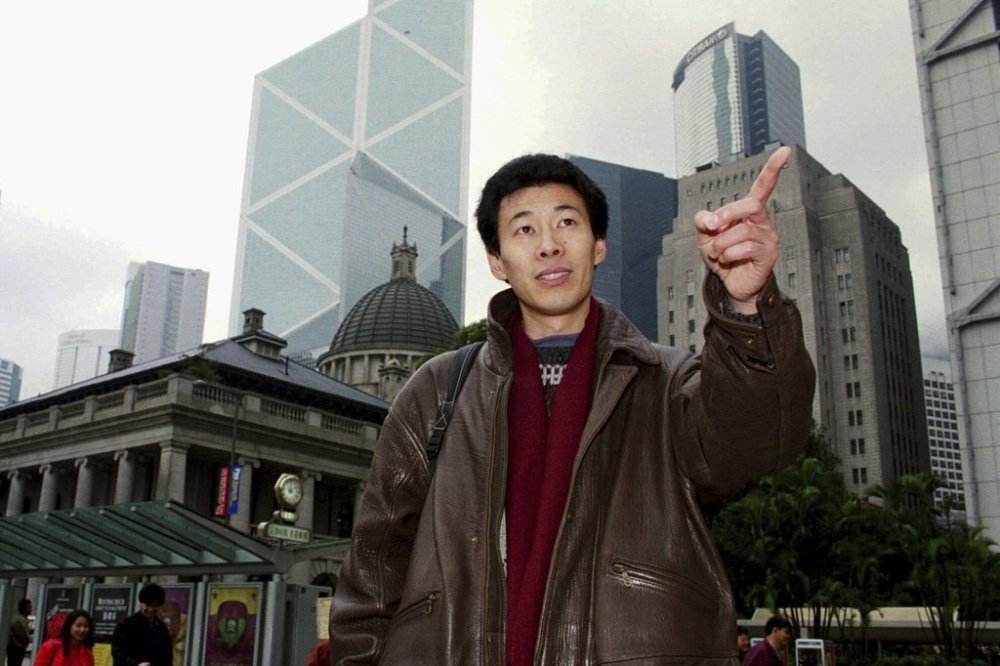 FILE - Chinese labor activist Han Dongfang gestures in Hong Kong street Saturday, Feb. 15, 1997. (AP Photo/Anat Givon, File)