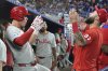 Philadelphia Phillies' Max Kepler, left, celebrates with Weston Wilson (37) after hitting a solo home run during the fourth inning of a baseball game against the Miami Marlins, Monday, June 16, 2025, in Miami. (AP Photo/Lynne Sladky)