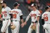 Baltimore Orioles' Jackson Holliday (7) and relief pitcher Andrew Kittredge, second from left, celebrate after their team's victory over the Texas Rangers in a baseball game, Monday, June 23, 2025, in Baltimore. (AP Photo/Stephanie Scarbrough)