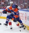 Oilers forward Ryan Nugent-Hopkins (93) and Florida Panthers defenceman Gustav Forsling (42) battle for the puck during the first overtime period in Game 2 of the NHL Stanley Cup final in Edmonton, on Friday, June 6, 2025. THE CANADIAN PRESS/Darryl Dyck
