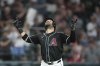 Arizona Diamondbacks' Eugenio Suárez looks up as he arrives at home plate after hitting a grand slam against the Seattle Mariners during the sixth inning of a baseball game Wednesday, June 11, 2025, in Phoenix. (AP Photo/Ross D. Franklin)