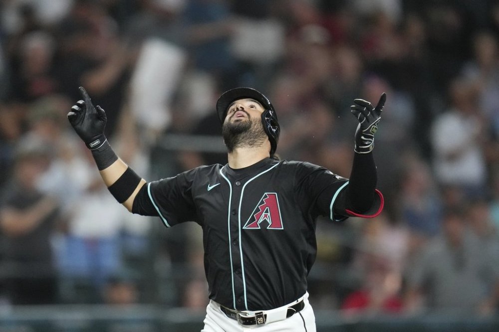 Arizona Diamondbacks' Eugenio Suárez looks up as he arrives at home plate after hitting a grand slam against the Seattle Mariners during the sixth inning of a baseball game Wednesday, June 11, 2025, in Phoenix. (AP Photo/Ross D. Franklin)