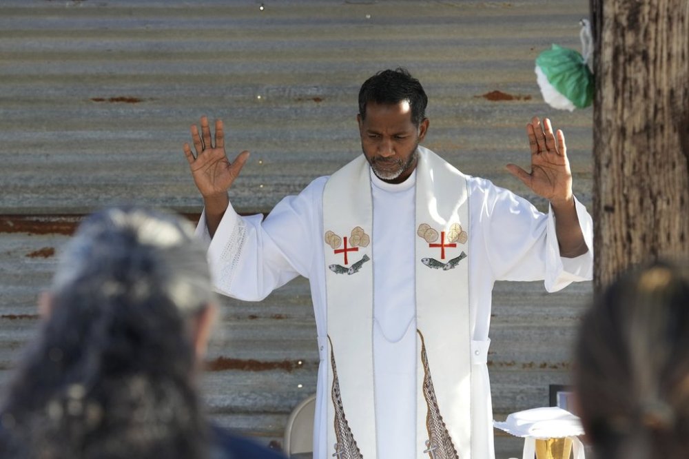 The Rev. Aro Varnabas starts the St. John the Baptist's feast day Mass in Saguaro National Park near Tucson, Ariz., on Tuesday, June 24, 2025. (AP Photo/Ross D. Franklin)