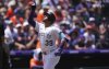 Colorado Rockies' Thairo Estrada gestures as he circles the bases after hitting a two-run home run against Houston Astros starting pitcher Brandon Walter in the first inning of a baseball game, Thursday, July 3, 2025, in Denver. (AP Photo/David Zalubowski)