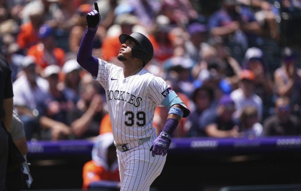 Colorado Rockies' Thairo Estrada gestures as he circles the bases after hitting a two-run home run against Houston Astros starting pitcher Brandon Walter in the first inning of a baseball game, Thursday, July 3, 2025, in Denver. (AP Photo/David Zalubowski)