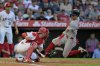 Boston Red Sox's Marcelo Mayer, right, scores past Los Angeles Angels catcher Logan O'Hoppe on a sacrifice fly by Red Sox's Nate Eaton in the third inning of a baseball game Tuesday, June 24, 2025, in Anaheim, Calif. (AP Photo/Jayne Kamin-Oncea)