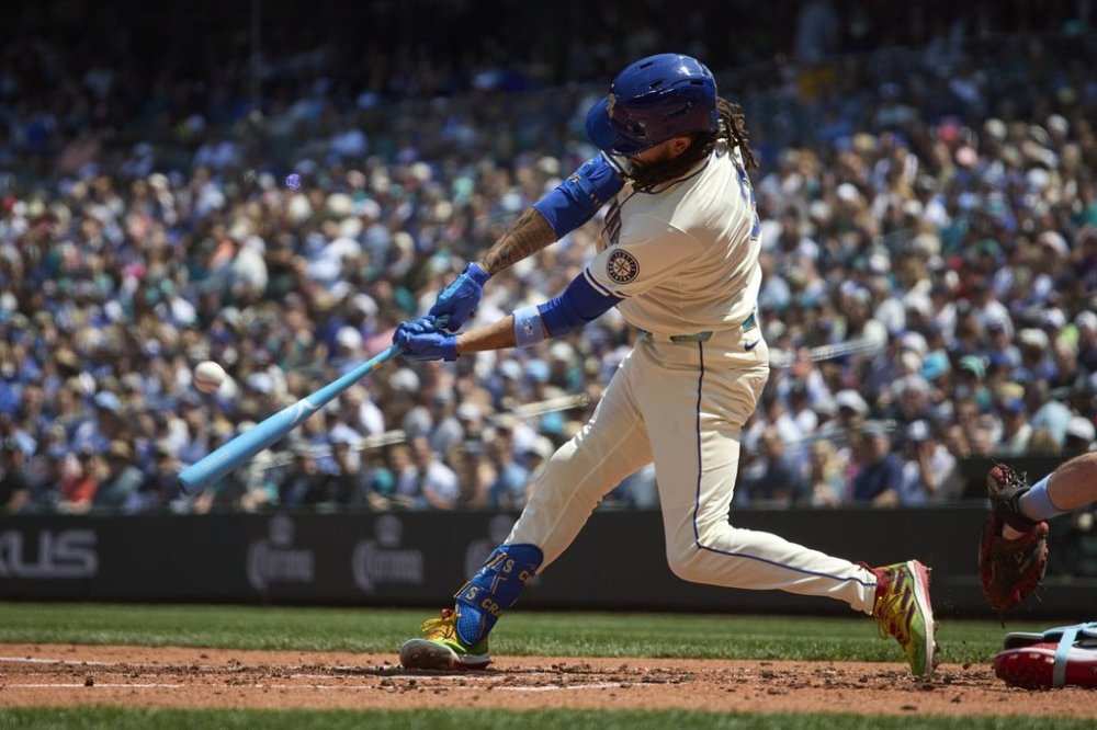 Seattle Mariners' J.P. Crawford hits a grand slam off Cleveland Guardians starting pitcher Luis L. Ortiz during the second inning of a baseball game Sunday, June 15, 2025, in Seattle. (AP Photo/John Froschauer)