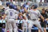 Texas Rangers' Wyatt Langford, right, celebrates his three-run home run with Kyle Higashioka, left, and Josh Smith during the second inning of baseball game against the Minnesota Twins, Thursday, June 12, 2025, in Minneapolis. (AP Photo/Matt Krohn)