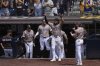 San Diego Padres right fielder Fernando Tatis Jr., center, celebrates with teammates after Jose Iglesias hit a two-RBI single during the seventh inning of a baseball game against the Kansas City Royals Sunday, June 22, 2025, in San Diego. (AP Photo/Gregory Bull)
