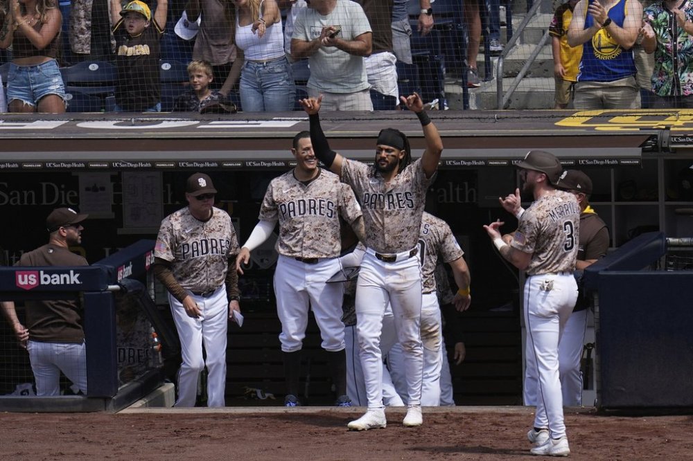 San Diego Padres right fielder Fernando Tatis Jr., center, celebrates with teammates after Jose Iglesias hit a two-RBI single during the seventh inning of a baseball game against the Kansas City Royals Sunday, June 22, 2025, in San Diego. (AP Photo/Gregory Bull)
