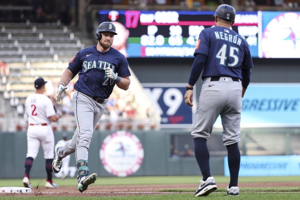 Seattle Mariners' Luke Raley (20) celebrates his three run home run as he runs the bases during the third inning against the Minnesota Twins of baseball game Monday, June 23, 2025, in Minneapolis. (AP Photo/Matt Krohn)