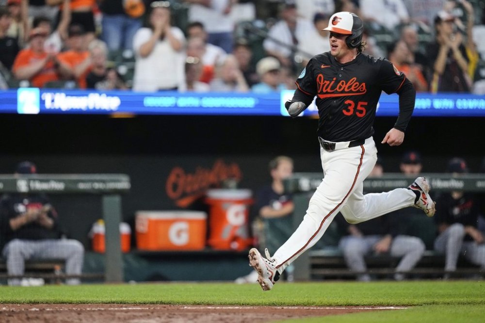 Baltimore Orioles' Adley Rutschman (35) advances toward home plate to score on an RBI hit in by Gunnar Henderson during the seventh inning of a baseball game against the Detroit Tigers, Wednesday, June 11, 2025, in Baltimore. (AP Photo/Stephanie Scarbrough)