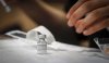 Nurse Iciar Bercian prepares a shot at a vaccine clinic for the homeless in Calgary, Wednesday, June 2, 2021. THE CANADIAN PRESS/Jeff McIntosh