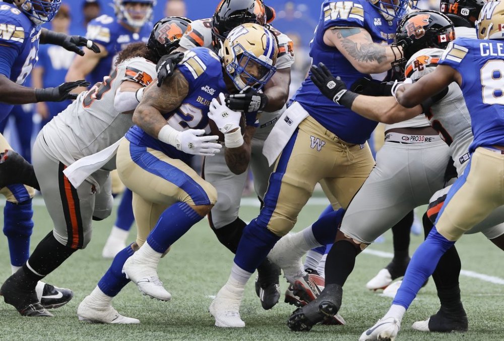 Winnipeg Blue Bombers' Brady Oliveira (20) runs for the first down during first half CFL action against the BC Lions in Winnipeg, Thursday, June 12, 2025. THE CANADIAN PRESS/John Woods