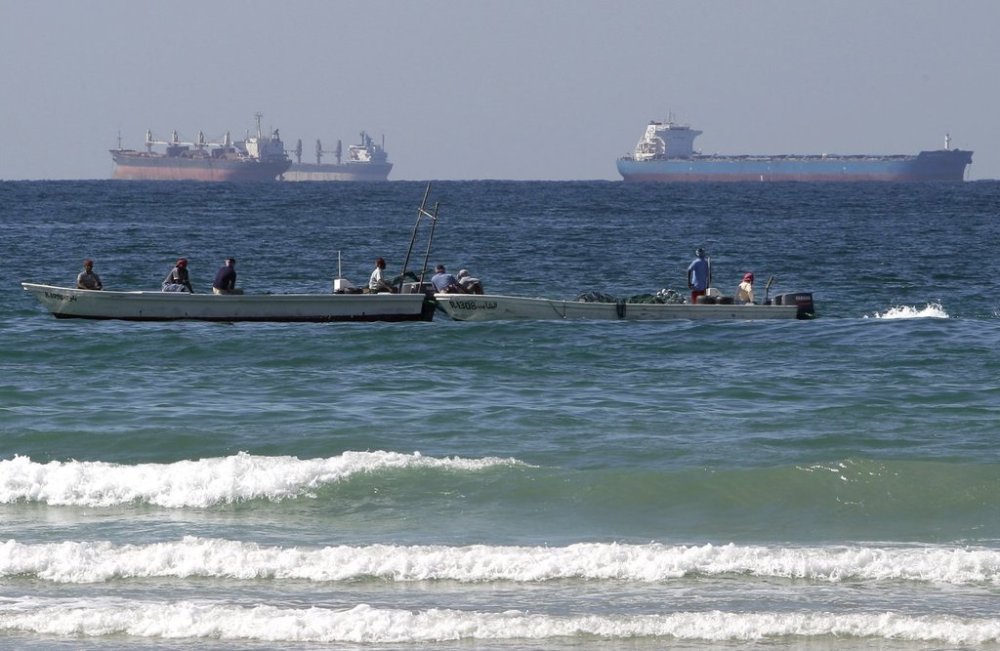 FILE - In this Jan. 19, 2012 file photo, fishing boats are seen in front of oil tankers south of the Strait of Hormuz, offshore the town of Ras Al Khaimah in United Arab Emirates. (AP Photo/Kamran Jebreili, File)