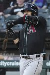 Arizona Diamondbacks' Eugenio Suárez reacts after being hit by pitch from Chicago White Sox starter Shane Smith during the first inning of a baseball game in Chicago, Monday, June 23, 2025. (AP Photo/Nam Y. Huh)