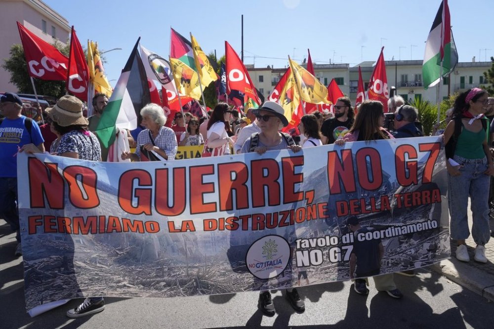 Demonstrators hold a banner reading: