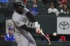 Chicago White Sox's Luis Robert Jr. hits a single that scored teammate Miguel Vargas during the fourth inning of a baseball game against the Texas Rangers, Saturday, June 14, 2025, in Arlington, Texas. (AP Photo/LM Otero)
