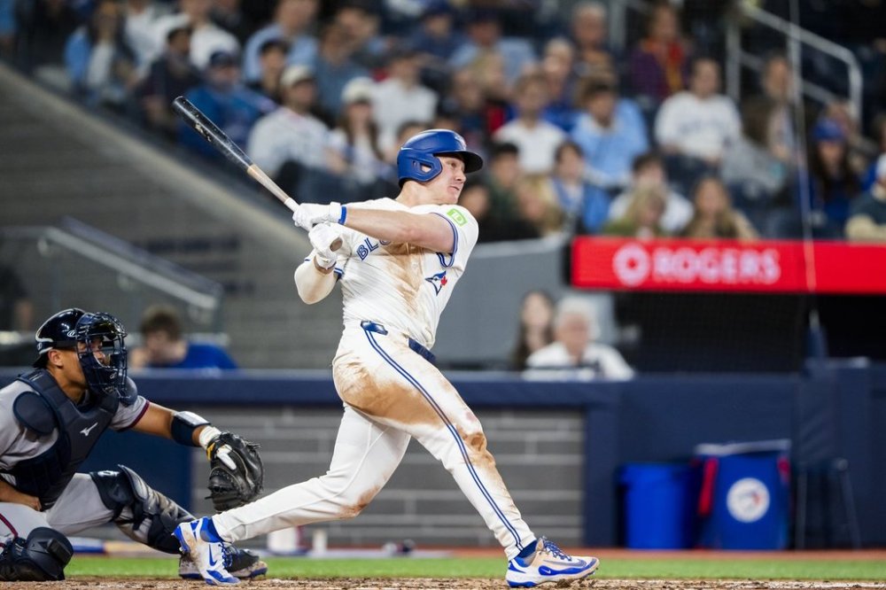Toronto Blue Jays outfielder Alan Roden (18) hits his first career home run against the Atlanta Braves during fifth inning MLB baseball action in Toronto on Tuesday, April 15, 2025. THE CANADIAN PRESS/Thomas Skrlj