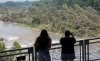 Onlookers review the damage along the Guadalupe River caused by recent flooding, Sunday, July 6, 2025, in Kerrville, Texas. (AP Photo/Rodolfo Gonzalez)