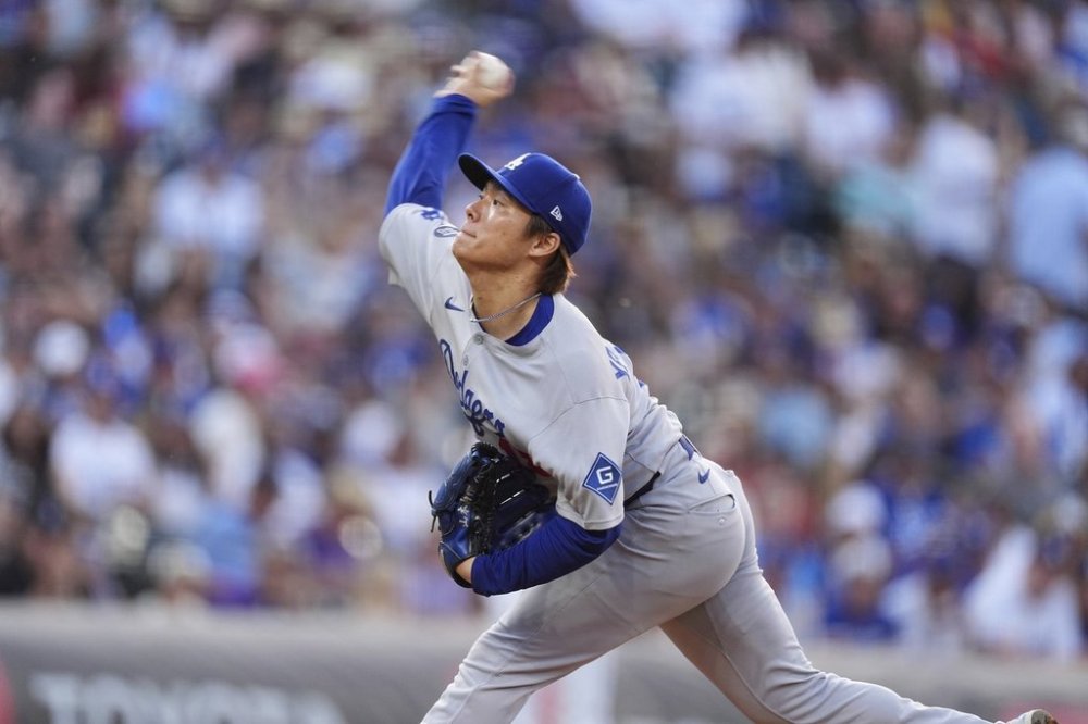 Los Angeles Dodgers starting pitcher Yoshinobu Yamamoto works against the Colorado Rockies in the first inning of a baseball game Wednesday, June 25, 2025, in Denver. (AP Photo/David Zalubowski)
