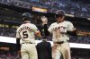 San Francisco Giants' Jung Hoo Lee, right, is congratulated by Mike Yastrzemski after scoring against the Miami Marlins on Christian Koss' sacrifice fly during the fifth inning of a baseball game Wednesday, June 25, 2025, in San Francisco. (AP Photo/Godofredo A. Vásquez)