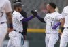 Colorado Rockies' Thairo Estrada, left, congratulates teammate Orlando Arcia (11) after Arcia's walkoff single to drive in two runs in the ninth inning of a baseball game against the San Francisco Giants, Thursday, June 12, 2025, in Denver. (AP Photo/David Zalubowski)