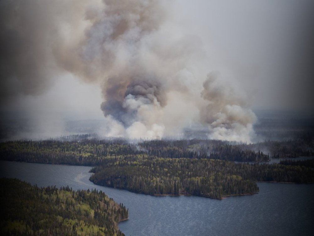 A wildfire burns in northern Manitoba near Flin Flon, as seen from a helicopter surveying the situation, Tuesday, May 14, 2024. THE CANADIAN PRESS/David Lipnowski