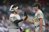Athletics catcher Willie MacIver (65) and pitcher Jacob Lopez (57) react after the final out against the Detroit Tigers in the sixth inning during a baseball game, Wednesday, June 25, 2025, in Detroit. (AP Photo/Paul Sancya)