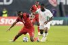 Canada's Cyle Larin, left, is knocked off the ball by Cote d'Ivoire's Franck Yannick Kessie during first half Canadian Shield Tournament action, in Toronto, on Tuesday June 10, 2025. THE CANADIAN PRESS/Chris Young