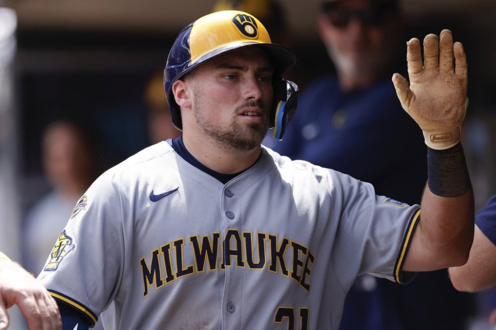 Milwaukee Brewers' Caleb Durbin is congratulated after scoring a run on a wild pitch by Minnesota Twins relief pitcher David Festa during the fourth inning of a baseball game Sunday, June 22, 2025, in Minneapolis. (AP Photo/Bailey Hillesheim)