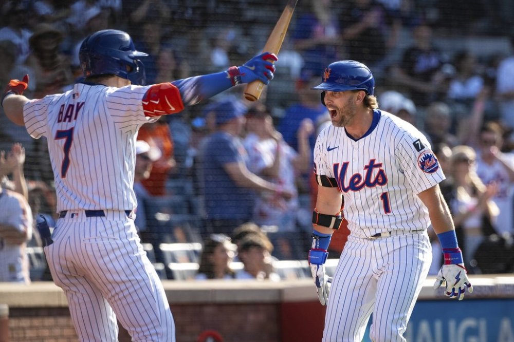 New York Mets' Jeff McNeil (1) celebrates with Brett Baty (7) after scoring on his two-run home run during the seventh inning of a baseball game against the New York Yankees, Friday, July 4, 2025, in New York. (AP Photo/Angelina Katsanis)