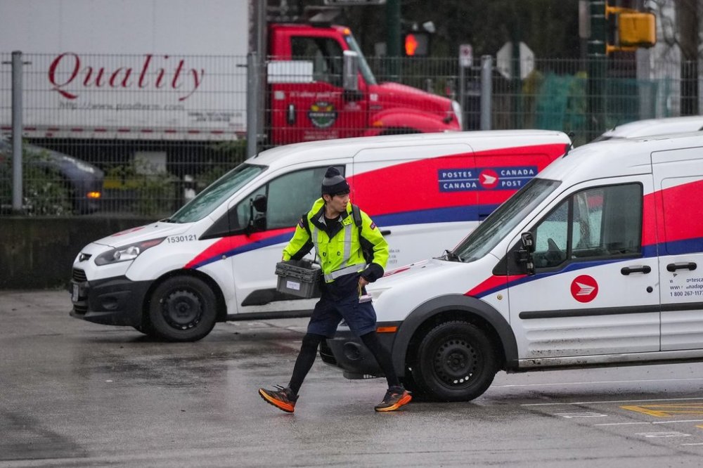 A Canada Post employee returns to a delivery depot in Vancouver, B.C., on Tuesday, Dec. 17, 2024. THE CANADIAN PRESS/Darryl Dyck