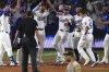 Los Angeles Dodgers' Will Smith, second from right, celebrates with teammates after hitting a walk-off home run as San Diego Padres third baseman Manny Machado walks off the field during the ninth inning of a baseball game, Wednesday, June 18, 2025, in Los Angeles. (AP Photo/Mark J. Terrill)