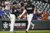 Baltimore Orioles' Coby Mayo, right, celebrates with interim third base/infield coach Buck Britton (46) after hitting a two-run home run during the eighth inning of a baseball game against the Tampa Bay Rays, Friday, June 27, 2025, in Baltimore. (AP Photo/Stephanie Scarbrough)