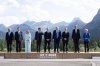 French President Emmanuel Macron asks Prime Minister Mark Carney where to look as they pose for the G7 family photo in Kananaskis, Alta., on Monday, June 16, 2025. THE CANADIAN PRESS/Adrian Wyld