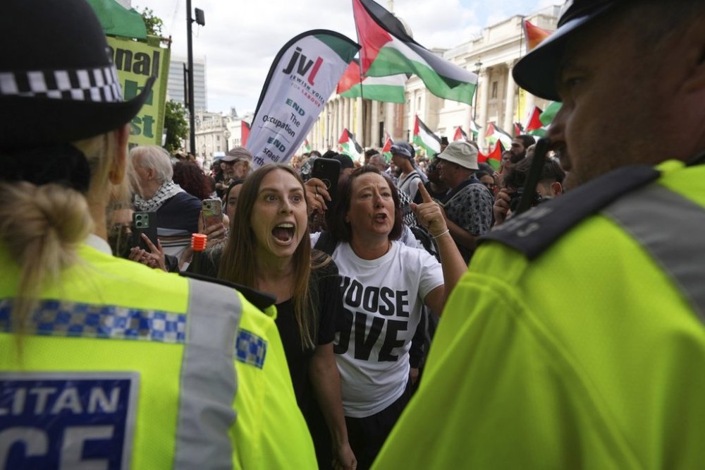 Demonstrators shout and gesture toward a police line during a protest by Palestine Action group in London, Monday, June 23, 2025. (AP Photo/Frank Augstein)