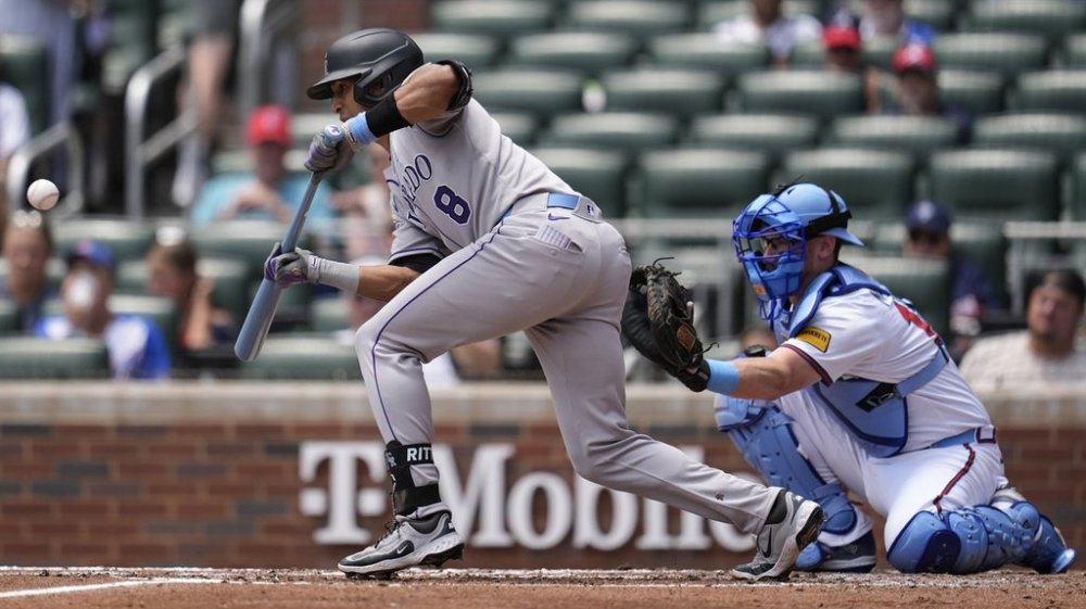 Colorado Rockies' Ryan Ritter (8) bunts against the Atlanta Braves in the third inning of a baseball game, Sunday, June 15, 2025, in Atlanta. (AP Photo/Mike Stewart)